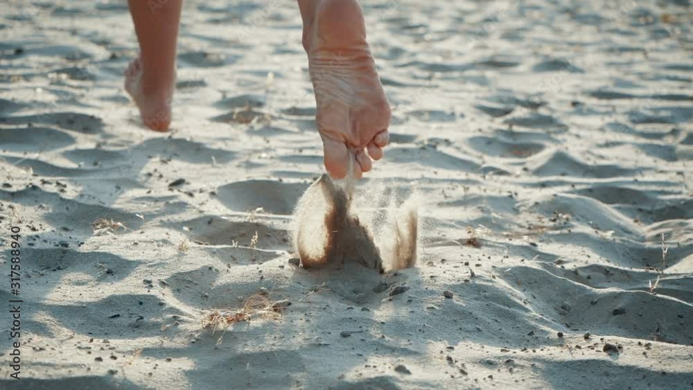 Feet running in the sand. Jogging man closeup barefoot runner legs and feet on the beach. Sporty legs exercising on a runner beach working out on a sunny day. Low section close-up in slow motion.