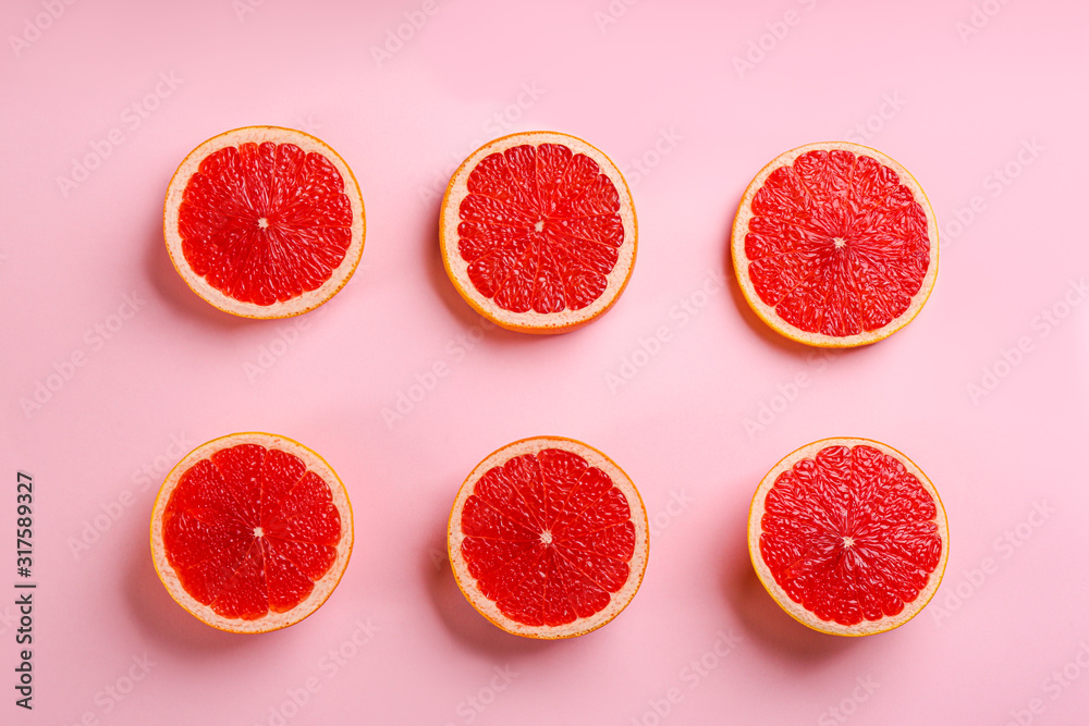 Tasty ripe grapefruit slices on pink background, flat lay Tasty ripe grapefruit slices on pink background, flat lay
