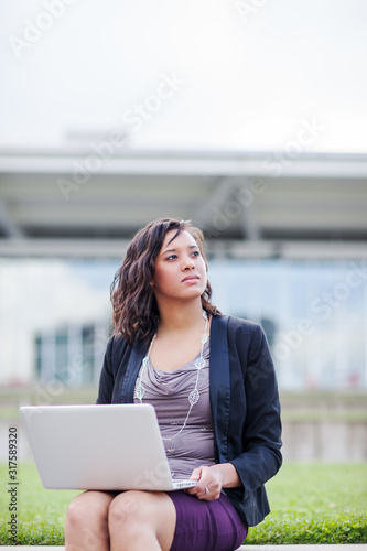 Happy African American businesswoman working on her laptop Free Download Happy African American businesswoman working on her laptop - GFXLoad