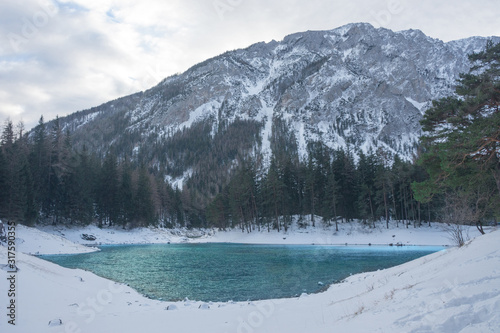 Green lake (Gruner see) in sunny winter day. Famous tourist destination for walking and trekking in Styria region, Austria