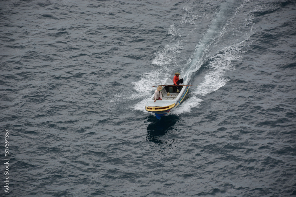 Fototapeta premium Man driving a boat very fast on the sea