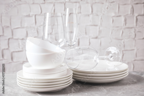 Set of clean dishware on marble table