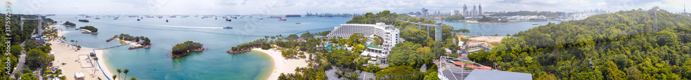 Panoramic aerial view of Siloso Beach and Sentosa Island at sunset, Singapore