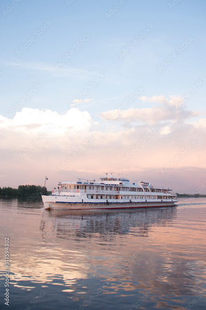 Motor ship on a background of pink sunset Motor ship on a background of pink sunset