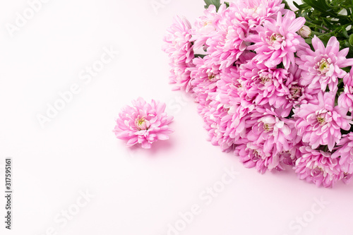 Bouquet of pink flowers on pink background. Romantic background for Valentine Day, Mothers Day or Birthday. Top view.