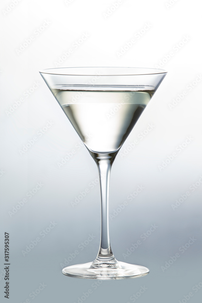 Thin glass goblet filled with martini isolated on neutral background Thin glass goblet filled with martini isolated on neutral background