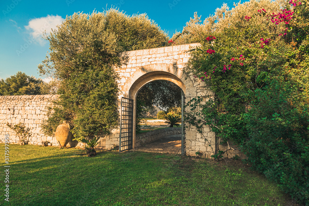 Old arc gateway in a garden in Italy 