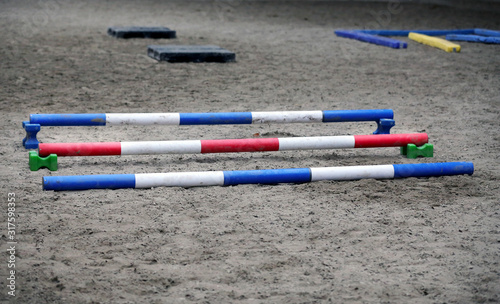 Colorful obstacles waiting for horse riders at rural equestrian centre