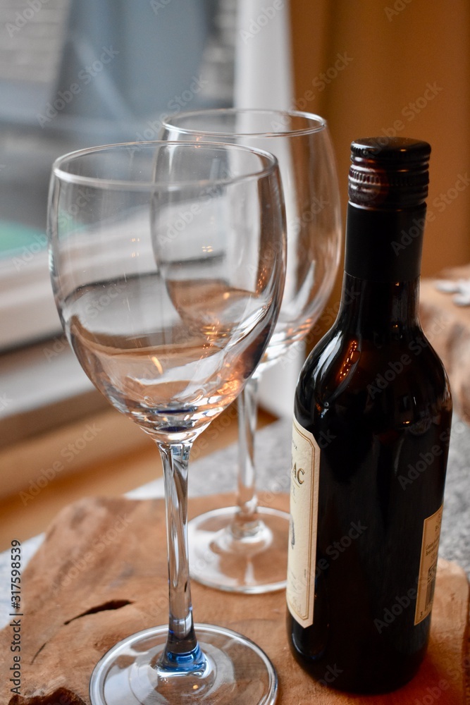 A bottle of wine and glasses on the table for a romantic dinner 