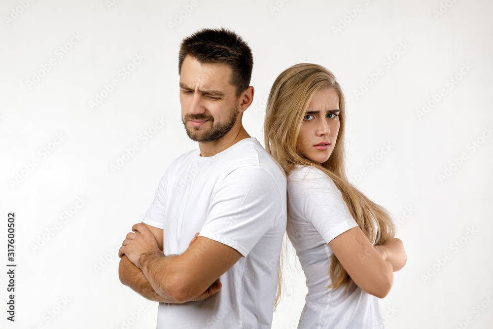 couple argued and resent each other. young woman and her boyfriend standing on white background couple argued and resent each other. young woman and her boyfriend standing on white background