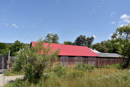 Building in Romania, with a red sheet roof