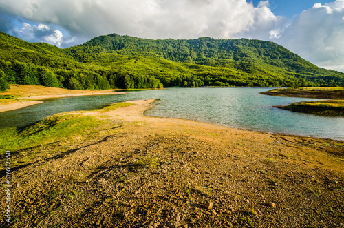 Water reservoir with green hill in background in Albania, near Fushe Stude photo