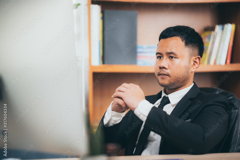 A smart business man who is working on a desk plan