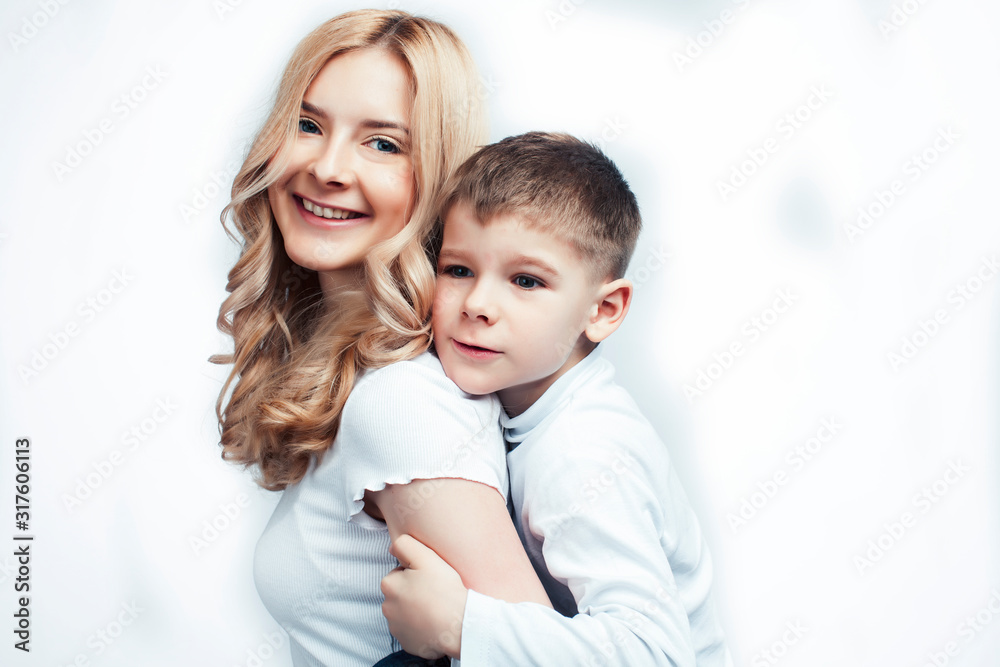 young modern blond curly mother with cute son together happy smiling family posing cheerful on white background, lifestyle people concept, sister and brother friends young modern blond curly mother with cute son together happy smiling family posing cheerful on white background, lifestyle people concept, sister and brother friends