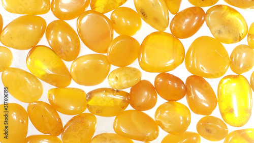 Natural polished amber on a white background