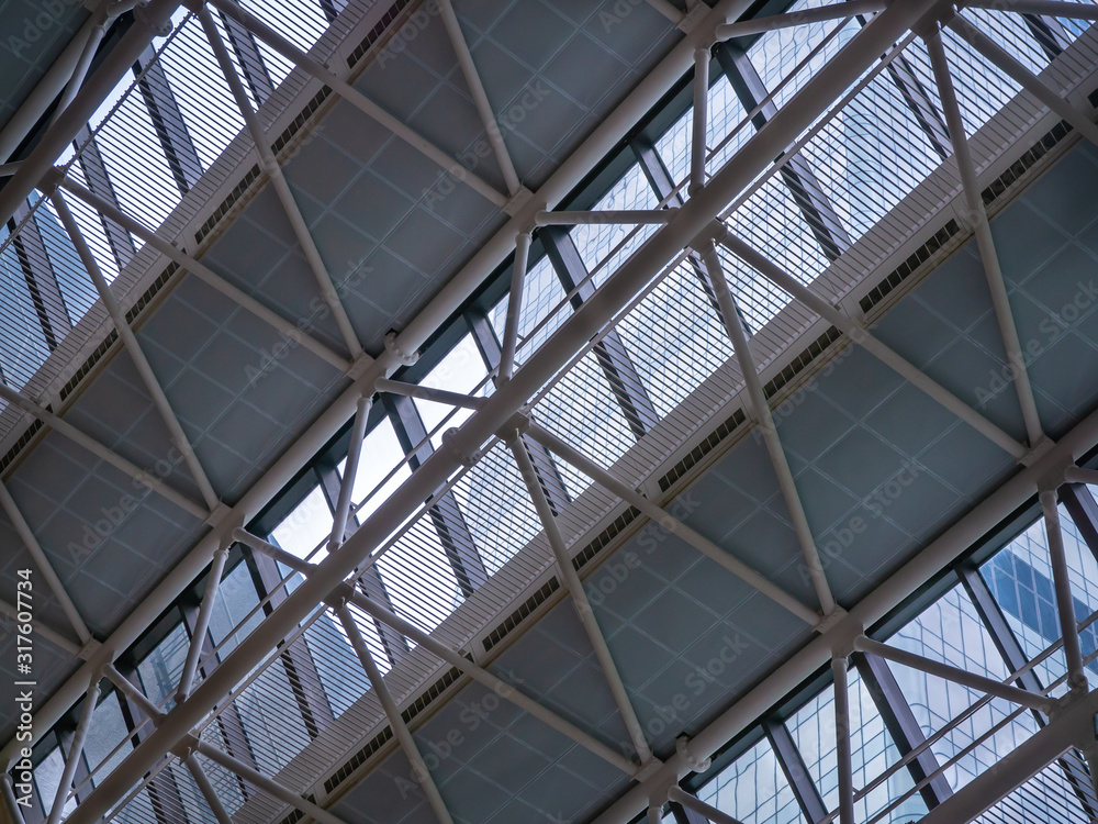 Details of steel structures of the sloping roof of a high-rise building. Glass mount. Skyscraper construction