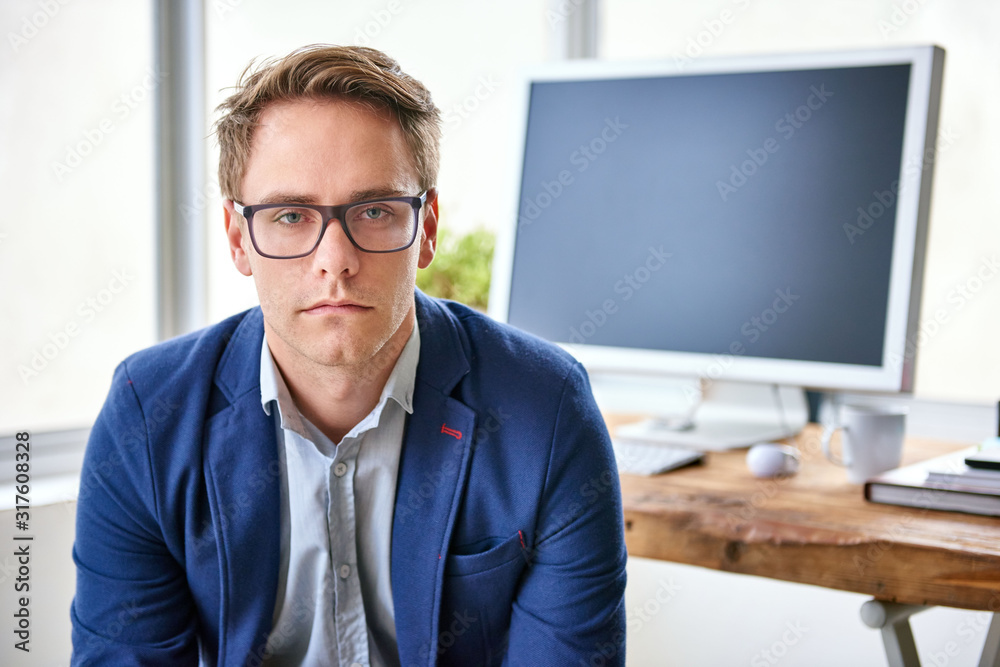 Fashionable businessman looking seriously at the camera