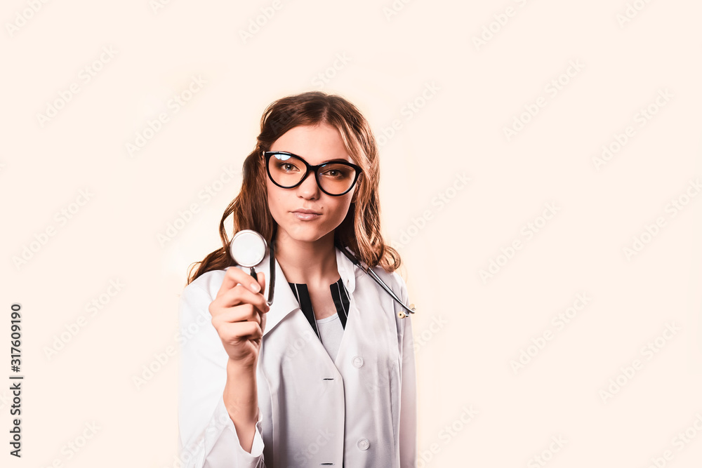 happy beautiful female doctor in medical coat . with a phonendoscope. at the medical examination of patients in the clinic. happy beautiful female doctor in medical coat . with a phonendoscope. at the medical examination of patients in the clinic.