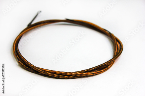 Royal fat bass strings isolated on white background. Copper orange strings on a light background from musical instruments.