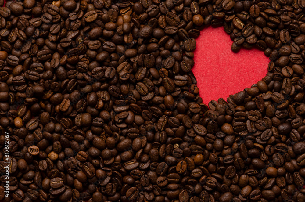 Red heart from coffee beans on coffee background Red heart from coffee beans on coffee background