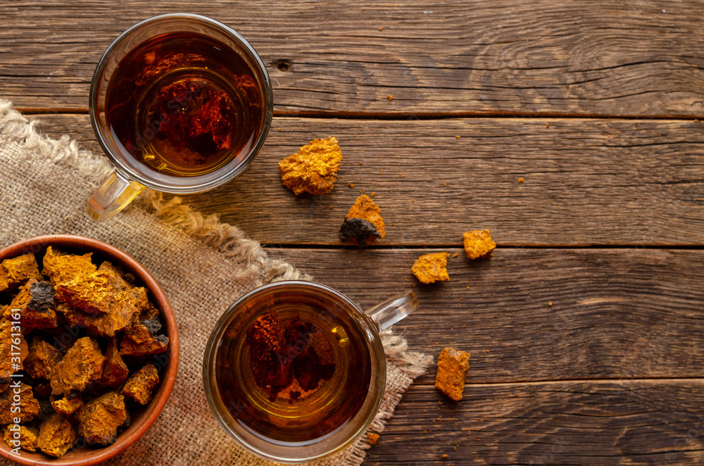 Chaga mushroom tea. medicinal drink with pieces of chaga Chaga mushroom tea. medicinal drink with pieces of chaga
