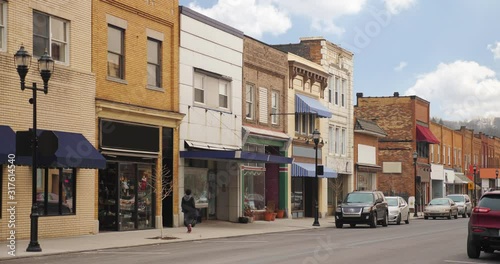 A daytime long shot establishing shot view of middle class businesses on the main street of a small town.  	 photo