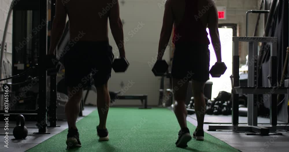 Two gay crossfire athletes do workout with weights. Two gay crossfire athletes do workout with weights.