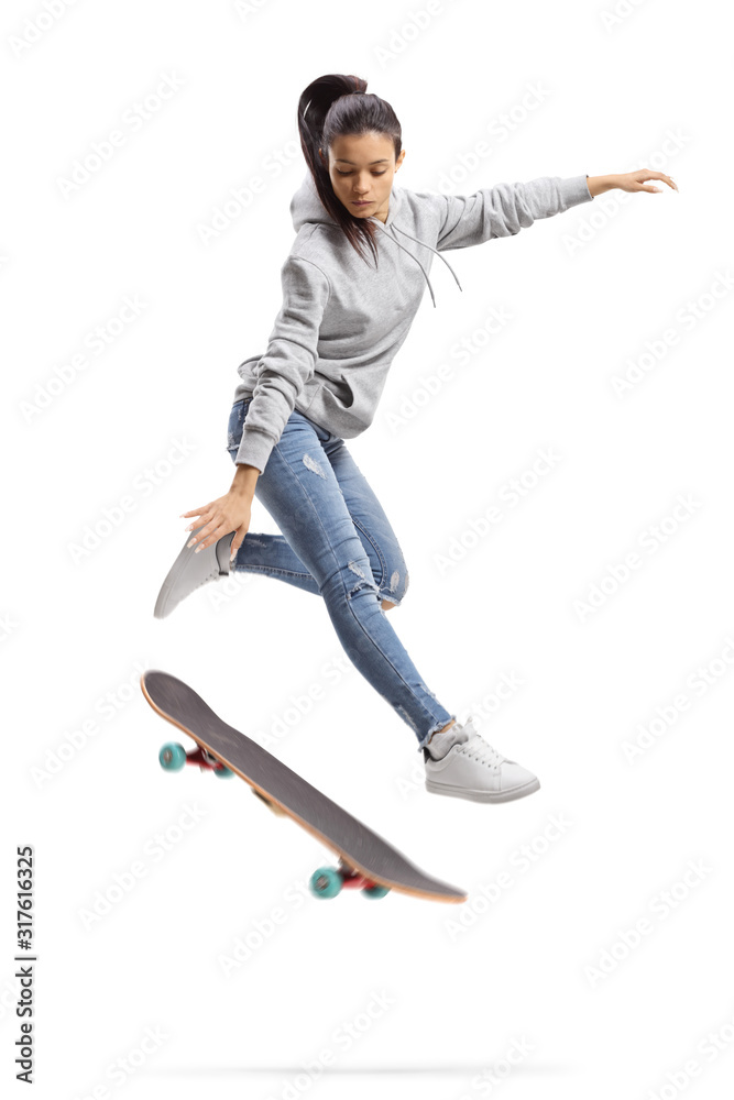 Girl in a hoodie jumping with a skateboard