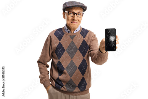 Sad senior man holding a phone with a broken screen © Ljupco Smokovski