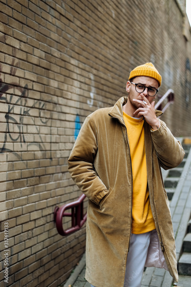 Photo of a young fashion stylish trendy look man model in color clothes modern style outdoor street style natural light Photo of a young fashion stylish trendy look man model in color clothes modern style outdoor street style natural light