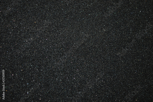 Texture of black sandpaper close-up. Small parts photo