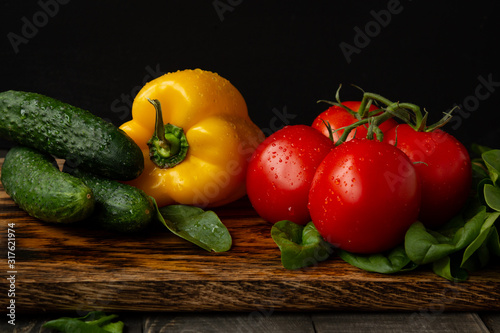 resh juicy vegetables, tomatoes and peppers, spinach leaves and cucumbers, salad, vegetarianism and healthy eating