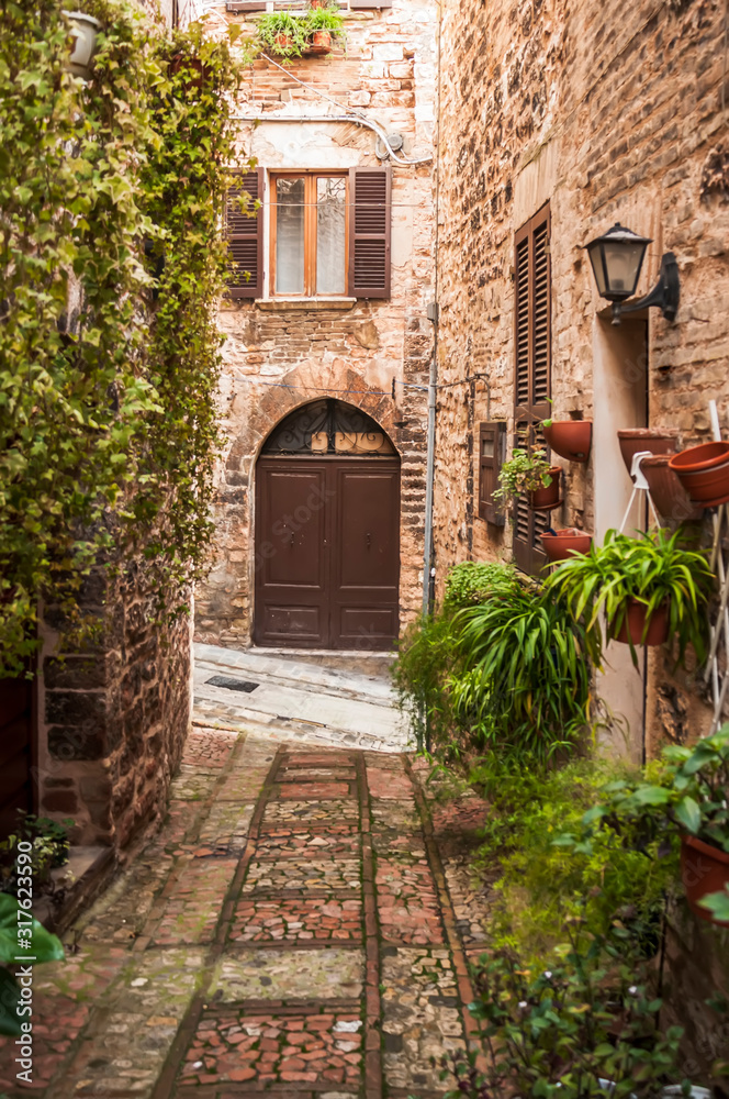 Narrow street in the smal viallge of Spello, Italy