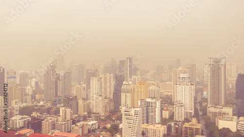 cityscape of high rise buildings in poor weather morning, haze of pollution covers city, global warming concept, pm2 5 air pollution