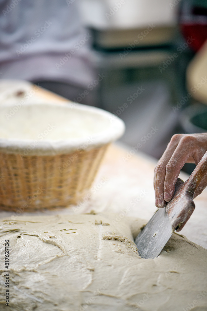 Hand of baker molding breads for baking Hand of baker molding breads for baking