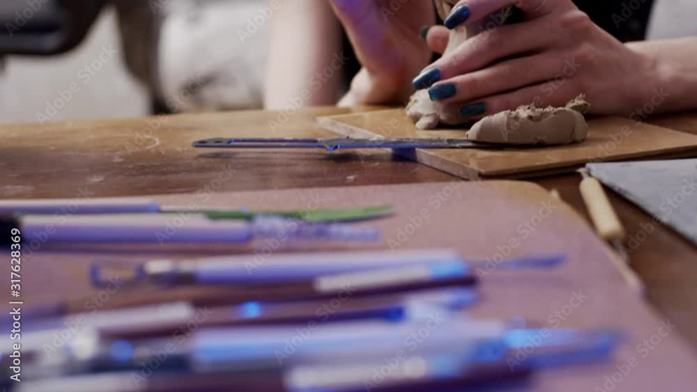 Two young artists sculpting using Plasticine (non-drying clay) Two young artists sculpting using Plasticine (non-drying clay)