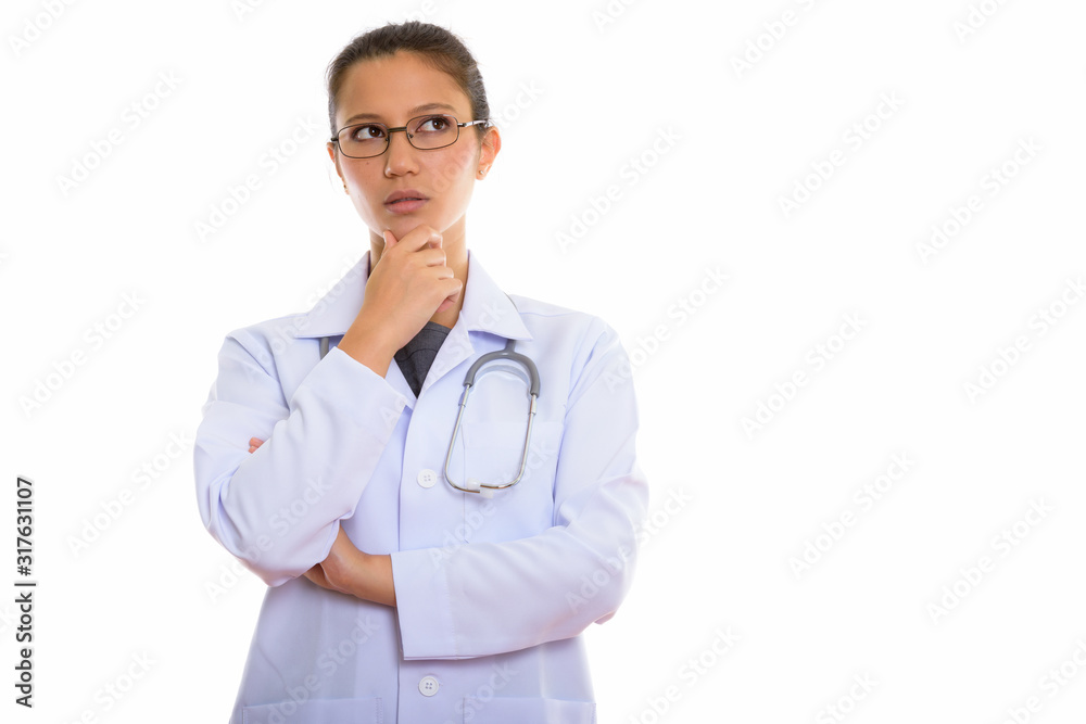 Young beautiful woman doctor thinking and looking up Young beautiful woman doctor thinking and looking up