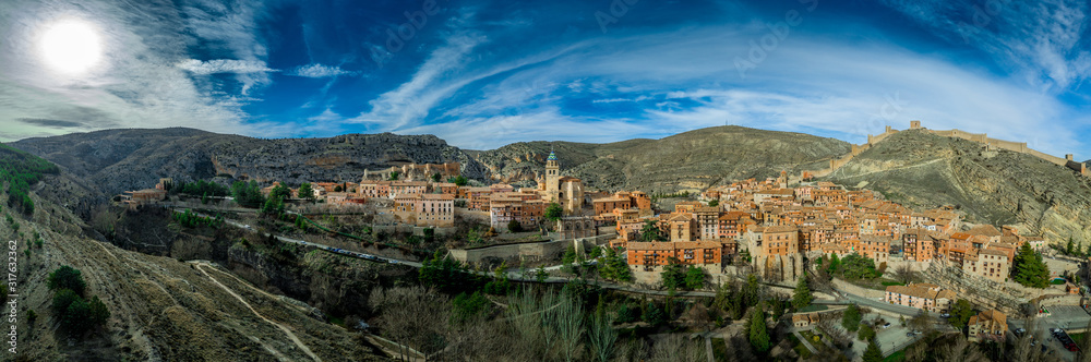 Aerial panorama view of Albarracin in Teruel Spain, with red sandstone terracotta medieval houses, Moorish castle and ancient city walls  voted most beautiful Spanish village