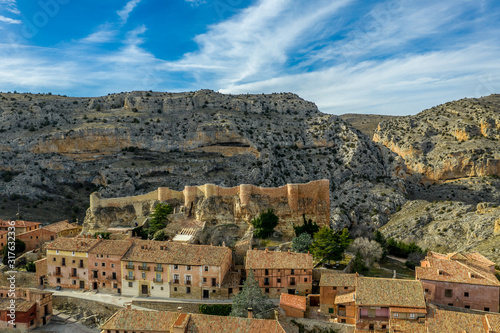 Aerial panorama view of Albarracin in Teruel Spain, with red sandstone terracotta medieval houses, Moorish castle and ancient city walls voted most beautiful Spanish village