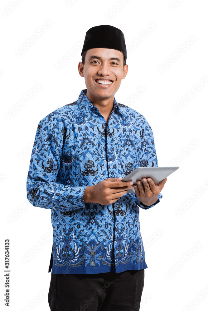 asian young man wearing batik korpri using tablet digital, government officials of Indonesia asian young man wearing batik korpri using tablet digital, government officials of Indonesia