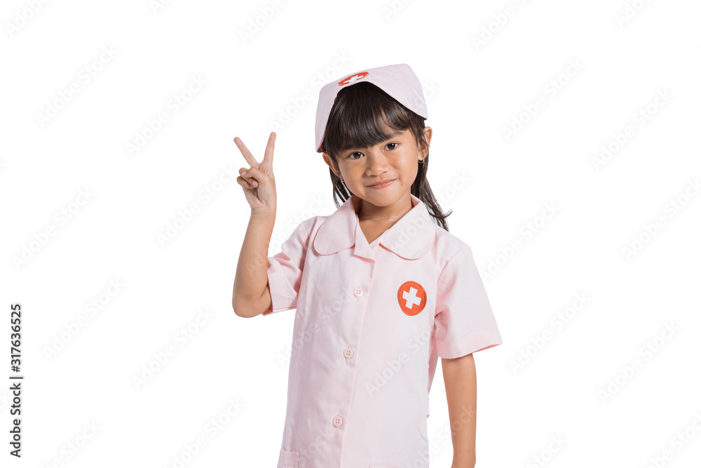 smiling little nurse wearing a uniform with her hands movement number two on an isolated background smiling little nurse wearing a uniform with her hands movement number two on an isolated background