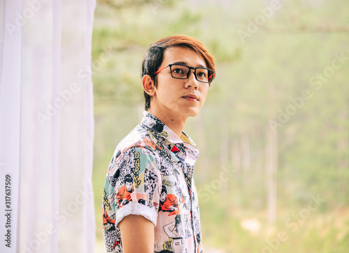 Asian handsome man standing on balcony