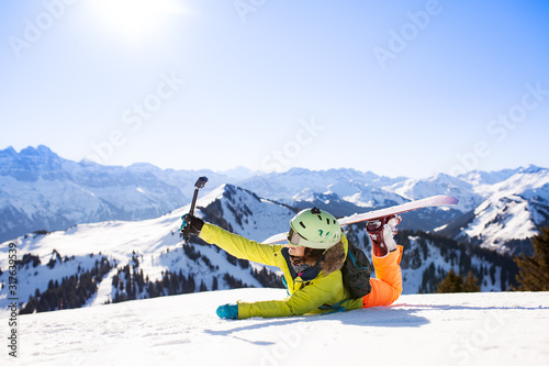 snowboarded girl posing on the snow with action camera