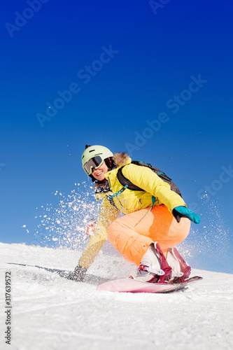 snowboarded girl jumping on the snow