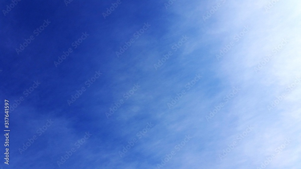 Beautiful blue sky backing shot with smoot clouds. Clear cloudscape area with just a blending cloud for use as a backing in your designing space. Royalty free stock photo. Beautiful blue sky backing shot with smoot clouds. Clear cloudscape area with just a blending cloud for use as a backing in your designing space. Royalty free stock photo.