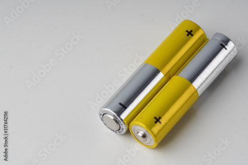 Two AAA batery over white background.