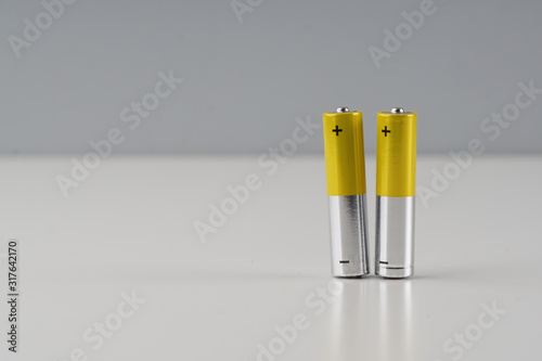 Two AAA batery over white background.