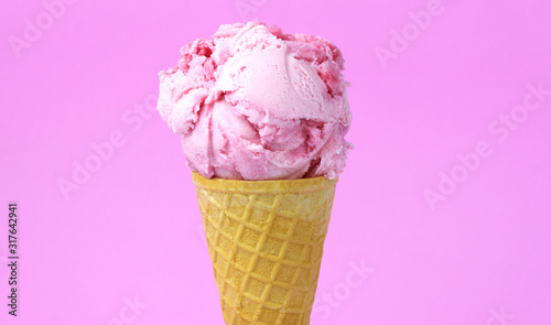 Ice cream flavoured Strawberry in waffle cone isolated on pink background, Closeup Front view Food concept..