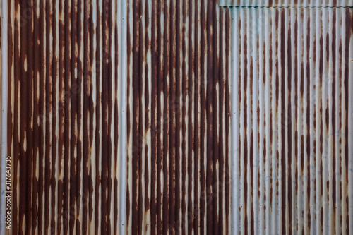 Rush metal background, Vintage rust door older slide gate, old rooftop wall with the rush water from steel, Corrugated shutter gate while raining with water rushing towards the gutter, closeup texture