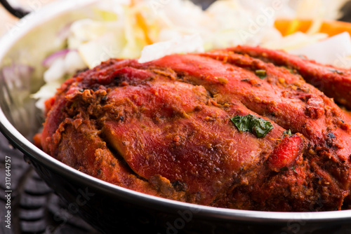 Close-up of a plate of chopped tandoori chicken